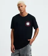Remera negra de algodón con cuello redondo y manga corta, corte comfort. Presenta un pequeño estampado circular en el pecho con el logo de la banda Red Hot Chili Peppers.