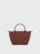 Cartera de mano Longchamp modelo Le Pliage One talla S, color amarillo, con solapa de cuero y cierre de botón a presión, asas cortas de mano y cierre superior con cremallera.