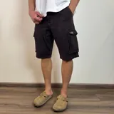 Bermuda cargo de jean color negro, con bolsillos laterales con solapa y cierre frontal.
