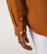 Camisa negra de lino con corte clásico, cuello camisero y mangas largas. Cierre frontal con botones.