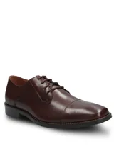 Zapato de vestir formal Hush Puppies modelo Jazz, confeccionado en cuero vacuno color marrón con diseño de puntera reforzada y cierre mediante cordones.