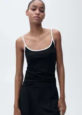 Musculosa negra con tirantes finos blancos y cuello redondo con ribete blanco. Diseño ajustado al cuerpo.