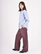 Pantalon de cuero sintetico color negro, de corte recto y holgado. Presenta cintura elastizada con cordon de ajuste y bolsillos laterales.