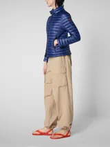 Campera acolchada ultraligera color azul marino, con capucha y cierre frontal de cremallera. Confeccionada con relleno sintético, es transpirable y resistente al viento y la humedad.