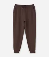 Pantalón jogger de pijama color negro, confeccionado en tejido de modal con mezcla de poliéster y elastano. Presenta cintura elástica con cordón de ajuste, bolsillos laterales y puños ajustados en el ruedo.
