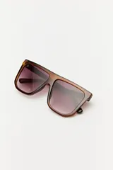 Lentes de sol negros con marco cuadrado y lentes grises. Diseño moderno y minimalista.