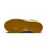 Championes Nike Dunk Low Twist en tonos amarillo y crema. Presentan un diseño deconstruido con swoosh flotante, refuerzos en la puntera y el talón, y una suela de goma en color amarillo vibrante.