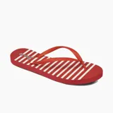 Ojotas Reef de dama, color rojo con rayas blancas y logo de la marca en la plantilla.