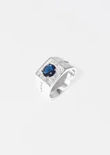 Anillo de plata 925 hipoalergénica con una zirconia azul central y pequeñas zirconias blancas alrededor.