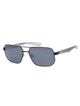 Lentes de sol Caterpillar modelo CTS 8013 con marco de metal negro y diseño de doble puente. Cuentan con cristales polarizados de color gris oscuro, patillas de doble inyección con detalles de goma y protección 100% UVA+B.