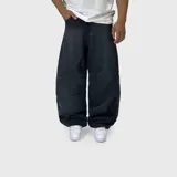 Jean ultra baggy de color negro con lavado acid wash y costuras curvas decorativas en las piernas.