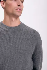 Sweater gris de punto con cuello redondo y mangas largas.