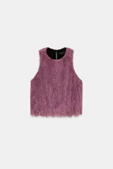Top de cuello redondo y manga sisa, confeccionado con un acabado de flecos largos en color lila. Presenta un diseño recto con cierre en la espalda mediante abertura y botón oculto.