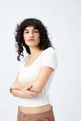 Remera blanca de punto acanalado con escote redondo amplio y mangas cortas.