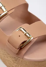 Sandalias negras de cuero con plataforma de madera y hebillas metálicas.