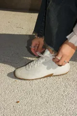 Championes de cuero con textura de pelo, color blanco, con suela de goma y cordones al tono. Diseño de estilo urbano y confortable.