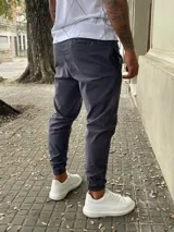 Pantalón babucha gris de gabardina con cintura elástica y puños ajustados.
