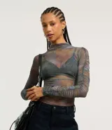 Blusa de tule con cuello alto y mangas largas con fruncido lateral.