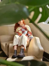 Sweater de punto con diseño geométrico en tonos celeste, marrón y beige.