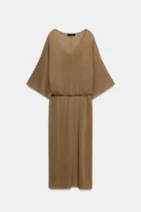 Vestido midi de punto color marrón con escote en V, mangas anchas y diseño holgado. Incluye un cinturón delgado marrón con hebilla metálica.