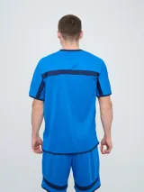 Remera deportiva de entrenamiento Umbro del Club Nacional de Football, color azul marino con detalles en blanco y líneas rojas en los hombros. Cuenta con el logo de la marca y el escudo del club en el pecho.