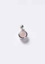 Dije circular con piedra de cuarzo rosa facetada engarzada en plata 925, con argolla superior para cadena.