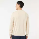 Sweater de punto de cuello redondo, manga larga y diseño liso, con puños y ruedo acanalados.