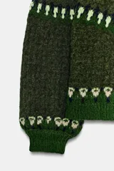 Jersey de punto con cuello subido y manga larga, diseño de jacquard con motivos geométricos en tonos verdes y crema.