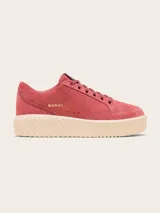 Championes Sorel modelo Ona Ave Low de gamuza rosada, con suela plataforma estriada color beige y el nombre de la marca impreso en dorado en el lateral.