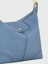 Cartera de hombro Longchamp modelo Le Pliage Xtra L, confeccionada en cuero de alta calidad en color azul. Presenta una solapa frontal con cierre de botón a presión metálico y una correa de hombro con detalles de cadena dorada.