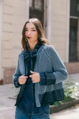 Saco tejido de punto con cuello a la base y manga larga, de diseño reversible y corte recto. Presenta un acabado bicolor que genera un efecto visual de contraste en los bordes y puños.