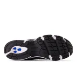 Championes New Balance modelo 509, de estilo retro running, en colores blanco, negro y gris. Presentan una capellada de cuero y malla, con el logo 'N' en el lateral y tecnología de amortiguación ABZORB en la mediasuela.