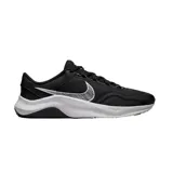 Championes Nike modelo Legend Essential 3, color negro con suela blanca y logo Swoosh en blanco. Diseño de malla transpirable con refuerzos laterales, ideal para entrenamiento.