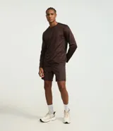 Remera deportiva de manga larga con cuello redondo, confeccionada en tejido técnico Dry Fit. Presenta un diseño liso con sutiles detalles reflectantes en los hombros.