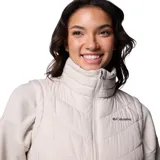 Chaleco acolchado Columbia Heavenly II, color gris claro, con cierre frontal de dos vías, cuello alto forrado en felpa y bolsillos laterales con cierre. Presenta tecnología Omni-Heat™ para retención de calor y Omni-Shield™ para repeler humedad.