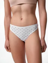 Bombacha tipo colaless de algodón color beige con estampado de pequeños lunares blancos. Presenta un diseño de tiro medio con costuras suaves para mayor comodidad.