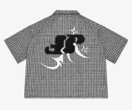 Camisa de corte boxy fit confeccionada en algodón con estampado de cuadros vichy en blanco y negro. Presenta un diseño gráfico artístico en color negro y blanco en la parte posterior.