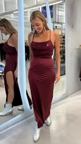 Vestido largo bordó de satén con tirantes finos regulables, escote drapeado con detalle de lentejuelas y tajo lateral profundo.