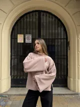 Polerón de cuello alto en color rosa, con diseño de calce holgado y mangas amplias. Confeccionado en tela suave y abrigada, ideal para un estilo urbano y relajado.