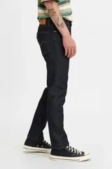 Jean de corte skinny, color azul oscuro, con tiro medio y cierre frontal con botón y cremallera. Presenta un diseño de cinco bolsillos clásico.