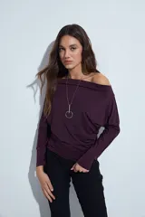 Top de manga larga color bordó con escote bote amplio, diseñado para usar con los hombros descubiertos. Presenta una silueta entallada y tejido liso de textura suave.