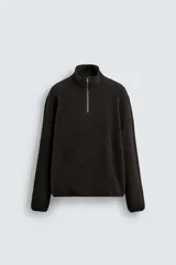 Sudadera de corte regular confeccionada en tejido de borreguillo con textura, cuello subido con cierre frontal de cremallera y manga larga con acabados en cinta.