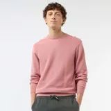 Sweater de punto con textura nido de abeja, color rosado, con cuello redondo y mangas largas.