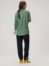 Camisa de algodón con estampado geométrico de ondas en tonos marrón y negro, corte holgado, mangas largas y cuello clásico.