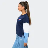 Buzo de cuello redondo Umbro del Club Nacional de Football, con diseño de bloques de color en azul marino, blanco y celeste. Presenta el logo de la marca y el escudo del club bordados en el pecho.
