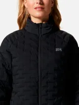 Campera técnica de plumón Mountain Hardwear, color negro, con diseño acolchado elástico, cuello alto, cierre frontal completo y bolsillos laterales con cremallera.