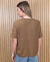 Cardigan calado de manga corta, tejido en punto con cierre frontal de botones y cuello redondo.