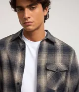 Camisa de franela a cuadros azul marino y beige, de corte comfort, con cuello inglés, abotonadura frontal, manga larga y bolsillo en el pecho.