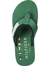 Ojotas Tommy Hilfiger verdes con suela blanca y tira de poliéster trenzado con logo de la marca.