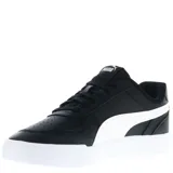 Championes urbanos Puma modelo Caven, color negro con detalles en blanco. Presentan diseño de corte bajo, cierre con cordones y suela de goma blanca.